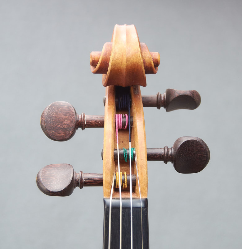 The scroll of a beautiful, handmade Titan Model Violin by Andrew Woods (front view). 