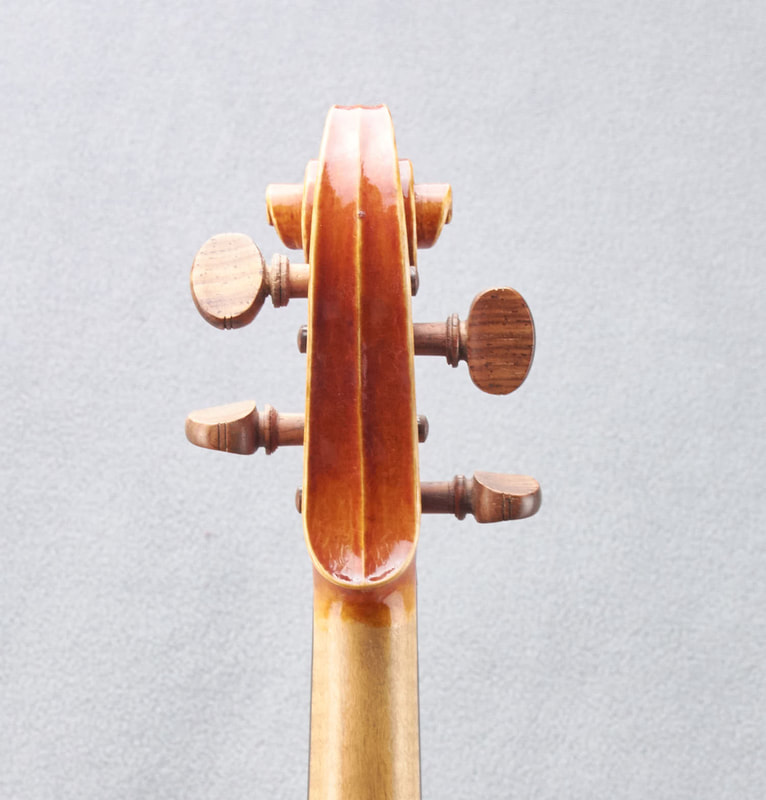 The scroll of a James Stephenson Violin (2016) with beautiful handmade varnish (back view).