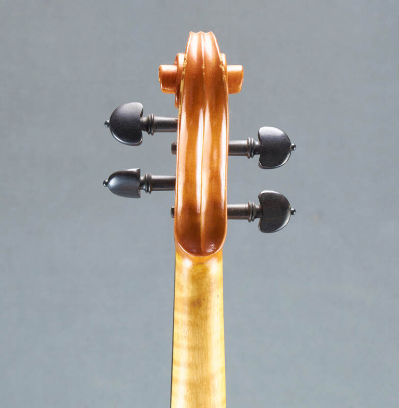 The scroll of a beautiful, handmade Tj Geever Violin (back view).