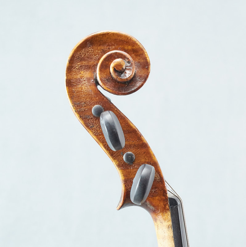 The scroll of a beautiful Fabienne Arimont handmade Violin (side view).