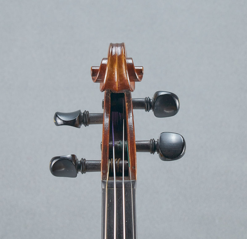 The scroll of a French, Antique Violin (1900) handmade with lovely warm tone (front view).