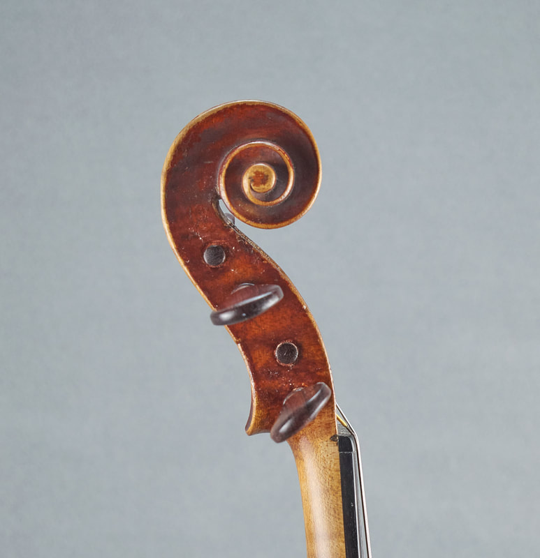 The scroll of an antique, handmade, French Neuner & Hornsteiner Violin (side view).