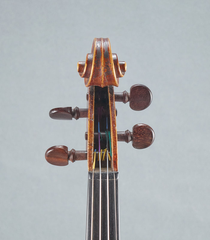 The scroll of an antique, handmade, French Neuner & Hornsteiner Violin (front view).