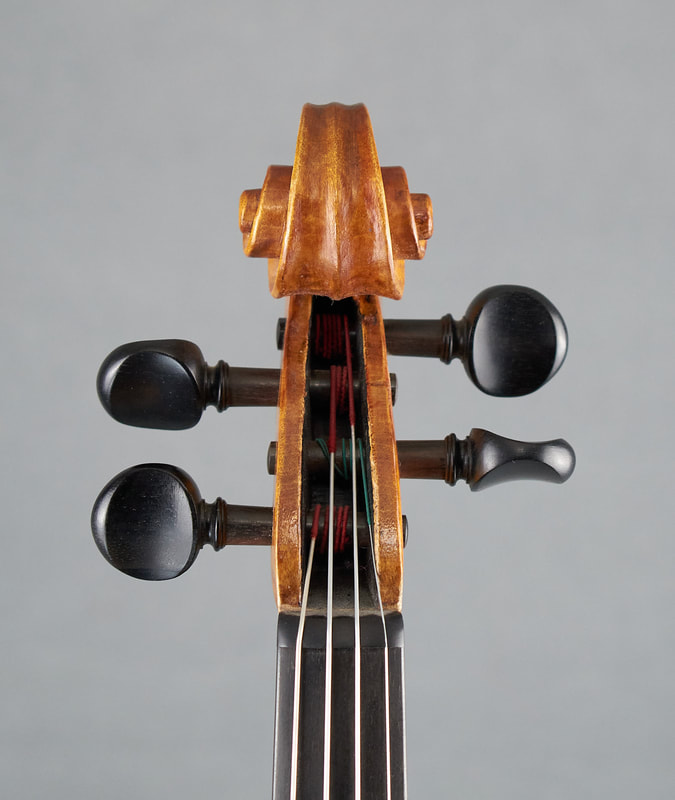 The scroll of a Theo Parmakis violin with exceptional sound and playability (front view).
