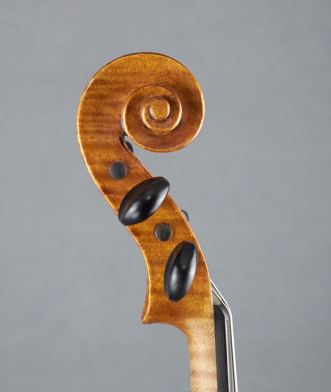 The scroll of a Theo Parmakis violin with exceptional sound and playability (side view).